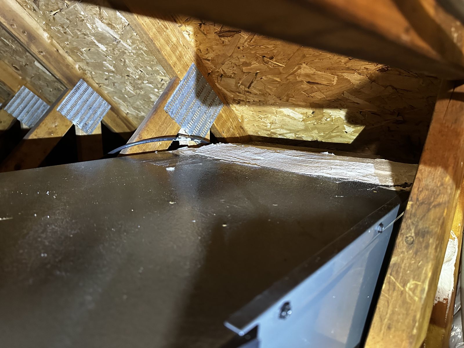 Professionally sealed and insulated duct seams in an attic